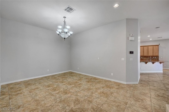 unfurnished room with a chandelier, baseboards, visible vents, and recessed lighting