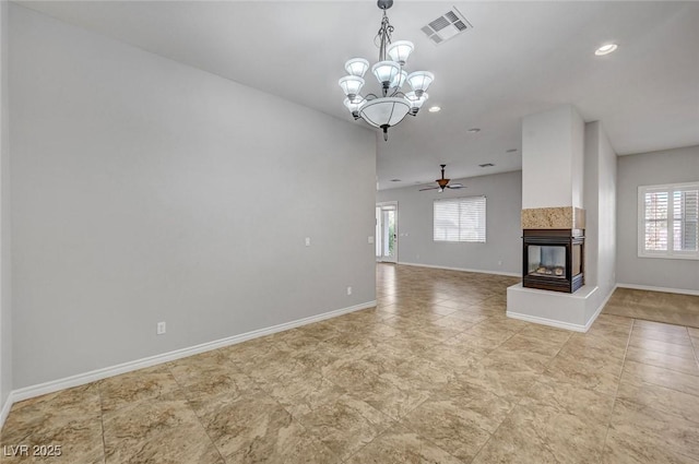 unfurnished living room featuring a multi sided fireplace, visible vents, baseboards, ceiling fan with notable chandelier, and recessed lighting