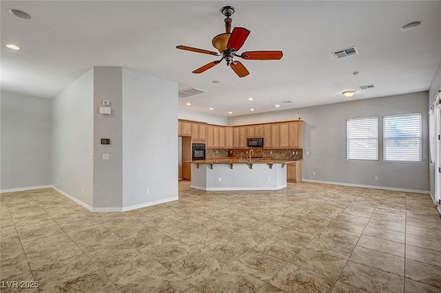 unfurnished living room featuring a ceiling fan, visible vents, and recessed lighting