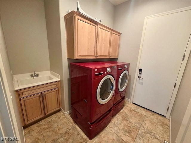 laundry area with baseboards, a sink, cabinet space, and independent washer and dryer
