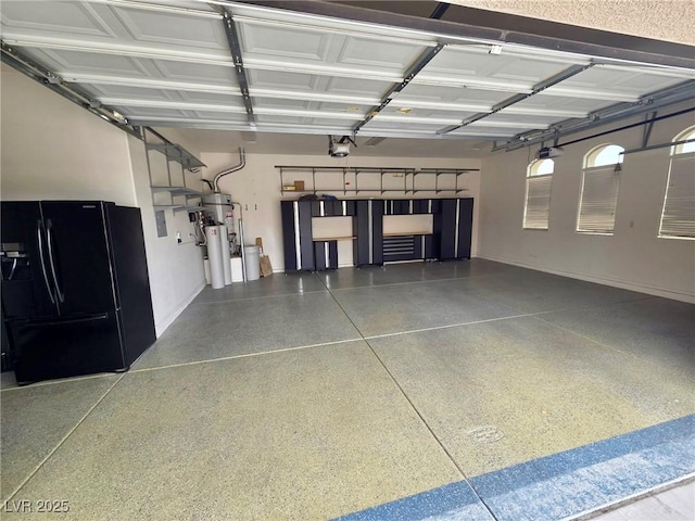 garage featuring baseboards, a garage door opener, and black refrigerator with ice dispenser