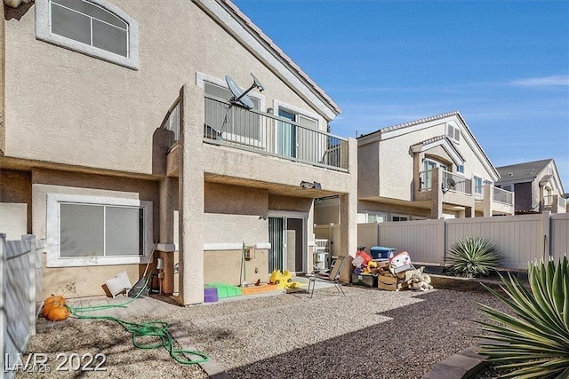 2509 April Breeze Ln, Henderson, NV 89002 - back of house with a patio area, fence, a balcony, and stucco siding