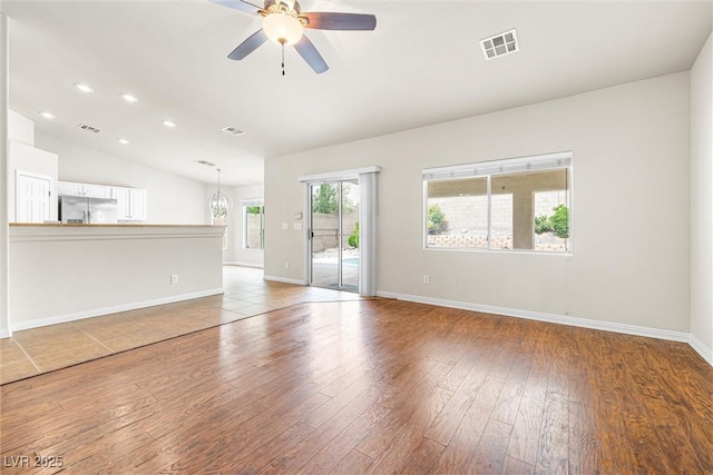 9539 Iris Flat Ct, Las Vegas, NV 89178 - unfurnished living room with hardwood / wood-style flooring, ceiling fan, lofted ceiling, baseboards, and recessed lighting