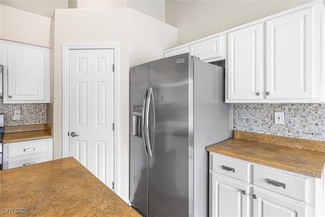 9539 Iris Flat Ct, Las Vegas, NV 89178 - kitchen with stainless steel fridge with ice dispenser, dark countertops, tasteful backsplash, and white cabinetry