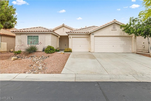 9539 Iris Flat Ct, Las Vegas, NV 89178 - view of front of property featuring stucco siding, a garage, concrete driveway, and a tiled roof