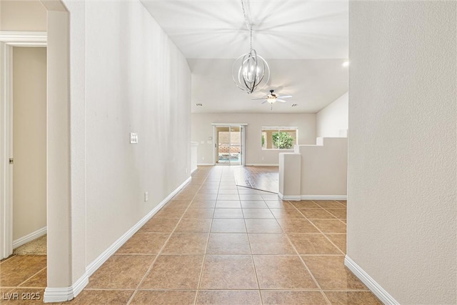 9539 Iris Flat Ct, Las Vegas, NV 89178 - corridor featuring a chandelier, light tile patterned floors, and baseboards