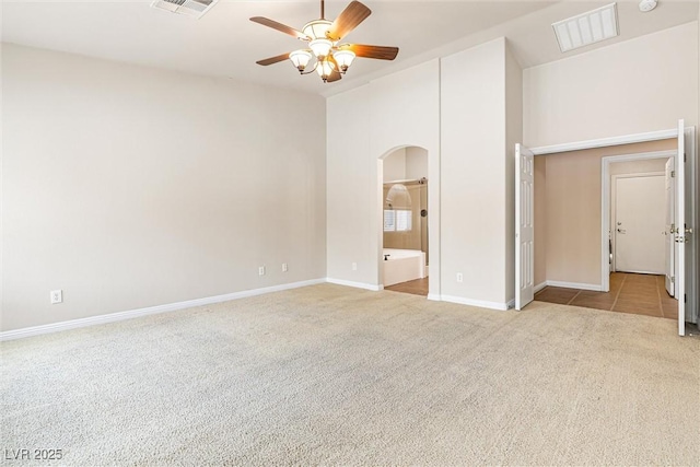 9539 Iris Flat Ct, Las Vegas, NV 89178 - carpeted empty room with a ceiling fan, arched walkways, and baseboards