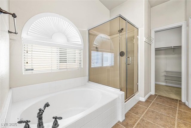 9539 Iris Flat Ct, Las Vegas, NV 89178 - full bathroom featuring a shower stall, a spacious closet, a garden tub, and tile patterned floors