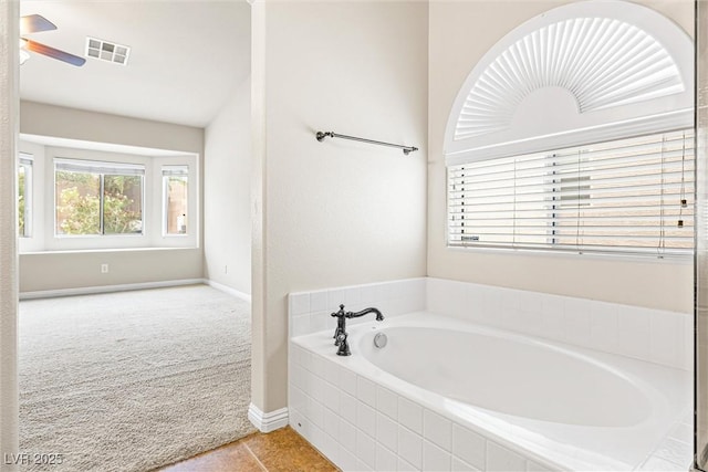 9539 Iris Flat Ct, Las Vegas, NV 89178 - full bathroom with a bath, baseboards, tile patterned floors, and ceiling fan