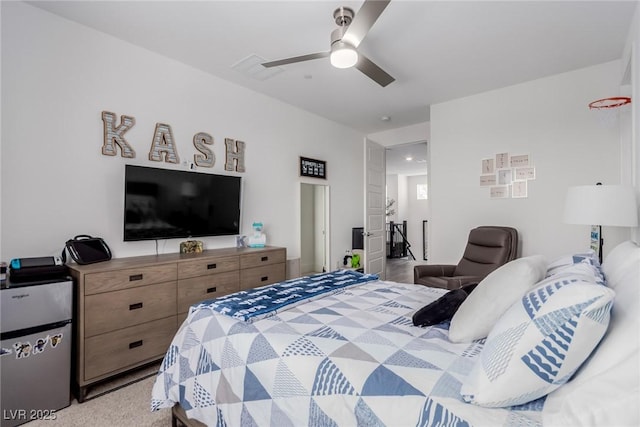 carpeted bedroom featuring ceiling fan and freestanding refrigerator
