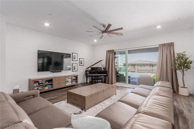 living room featuring wood finished floors, a ceiling fan, and recessed lighting