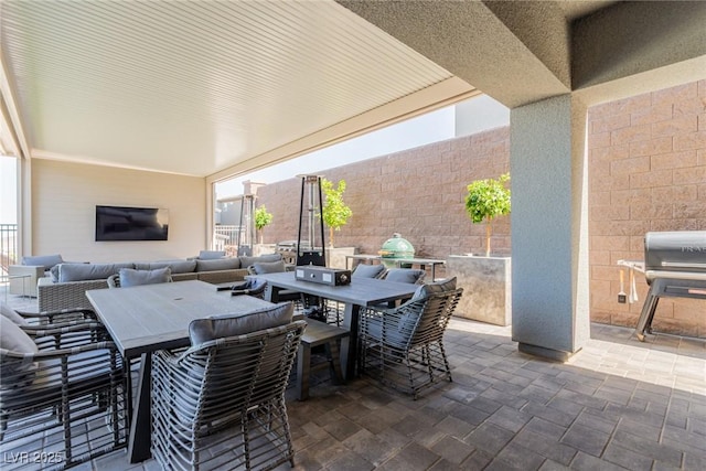 view of patio featuring outdoor dining area, area for grilling, and fence