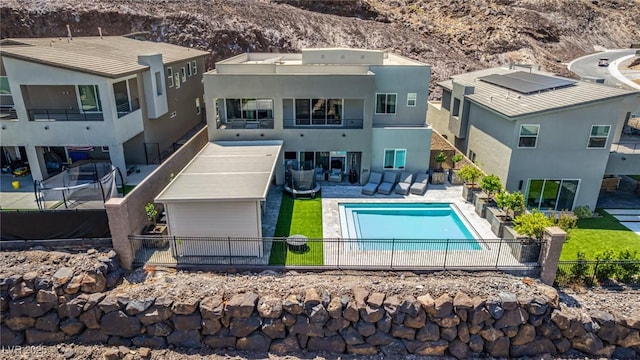 back of house featuring a fenced backyard, a patio area, stucco siding, and a mountain view