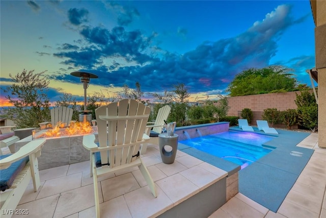 view of pool featuring a fenced in pool, a patio area, a fenced backyard, and an outdoor fire pit