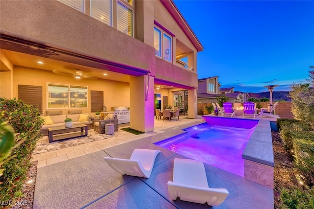 view of swimming pool with an outdoor living space, a patio, outdoor dining area, and a ceiling fan