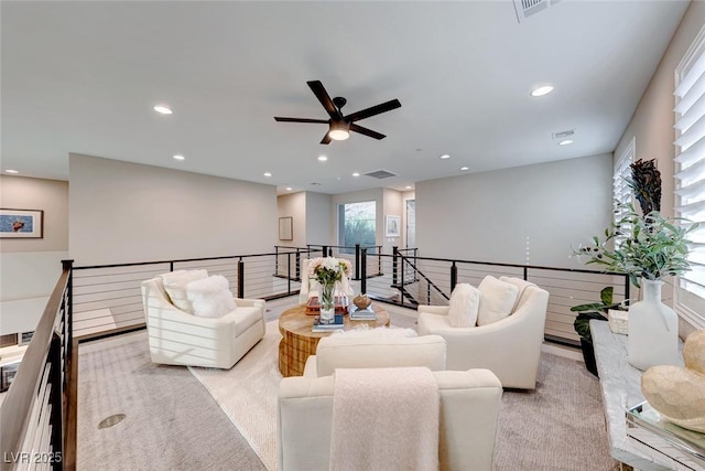 living room with light carpet, recessed lighting, visible vents, and ceiling fan