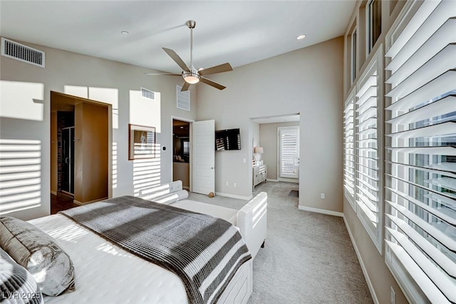 bedroom featuring high vaulted ceiling, light colored carpet, baseboards, and visible vents