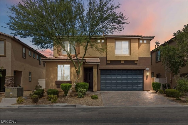 5317 Golden Melody Ln, North Las Vegas, NV 89081 - view of front of property with stucco siding, an attached garage, and decorative driveway