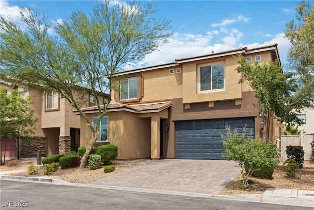 5317 Golden Melody Ln, North Las Vegas, NV 89081 - view of front of property with stucco siding, an attached garage, and driveway
