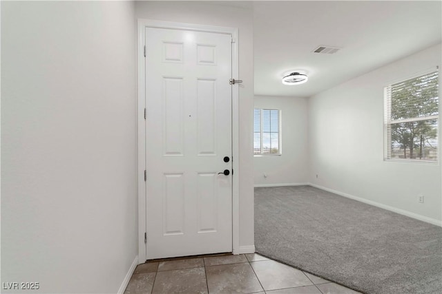 5317 Golden Melody Ln, North Las Vegas, NV 89081 - foyer with light carpet, baseboards, and light tile patterned flooring