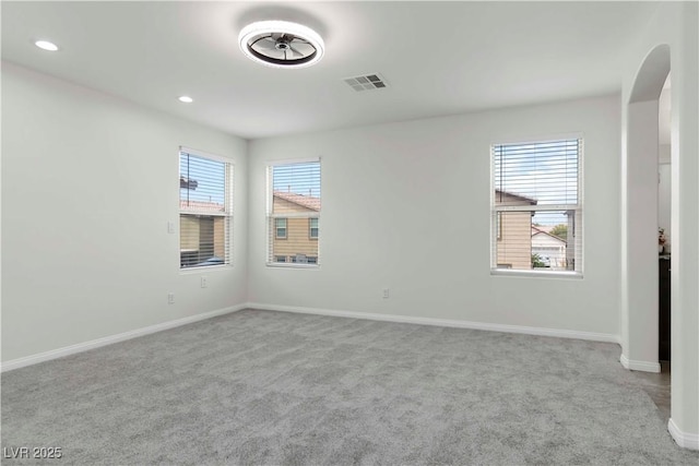5317 Golden Melody Ln, North Las Vegas, NV 89081 - empty room featuring carpet floors, baseboards, arched walkways, and recessed lighting