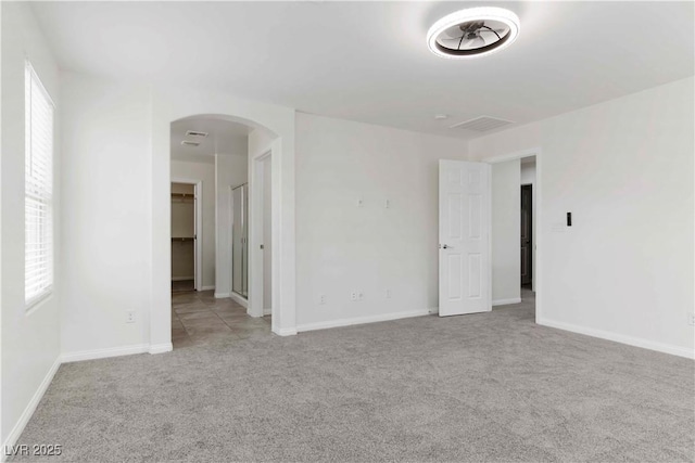 5317 Golden Melody Ln, North Las Vegas, NV 89081 - spare room featuring arched walkways, carpet, plenty of natural light, and baseboards
