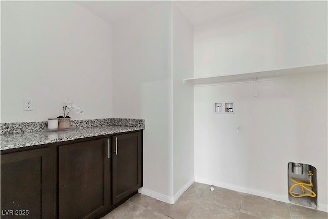 5317 Golden Melody Ln, North Las Vegas, NV 89081 - washroom featuring hookup for a washing machine, light tile patterned floors, cabinet space, and baseboards