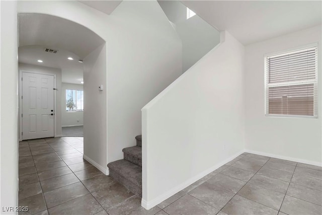 5317 Golden Melody Ln, North Las Vegas, NV 89081 - stairs with tile patterned floors, recessed lighting, baseboards, and arched walkways
