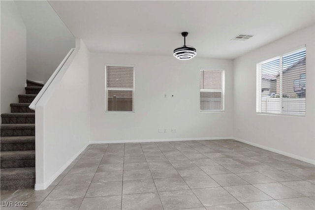 5317 Golden Melody Ln, North Las Vegas, NV 89081 - spare room with light tile patterned floors, stairs, and baseboards