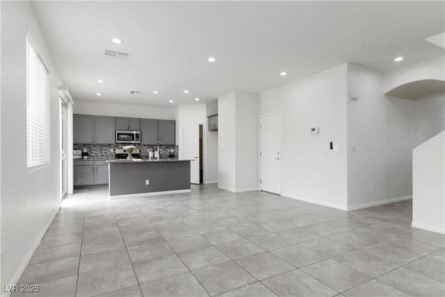 5317 Golden Melody Ln, North Las Vegas, NV 89081 - unfurnished living room featuring light tile patterned flooring, recessed lighting, and baseboards