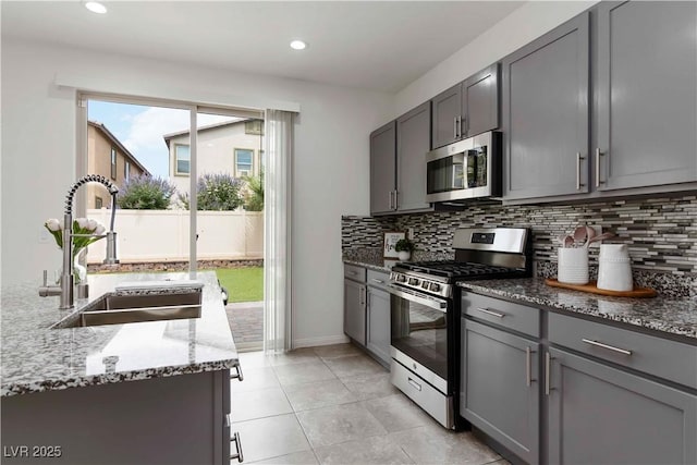 5317 Golden Melody Ln, North Las Vegas, NV 89081 - kitchen with appliances with stainless steel finishes, a sink, gray cabinetry, and recessed lighting