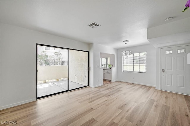 4855 S Torrey Pines Dr Unit 101, Las Vegas, NV 89103 - unfurnished room with light wood finished floors, a chandelier, and a smoke detector
