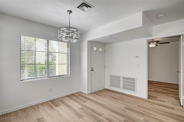 4855 S Torrey Pines Dr Unit 101, Las Vegas, NV 89103 - unfurnished dining area featuring light wood finished floors, a chandelier, and ceiling fan