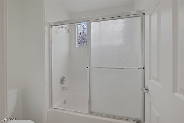 9705 Floweret Ave, Las Vegas, NV 89117 - full bathroom featuring toilet and bath / shower combo with glass door
