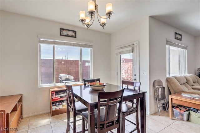 dining room featuring light tile patterned floors and a notable chandelier