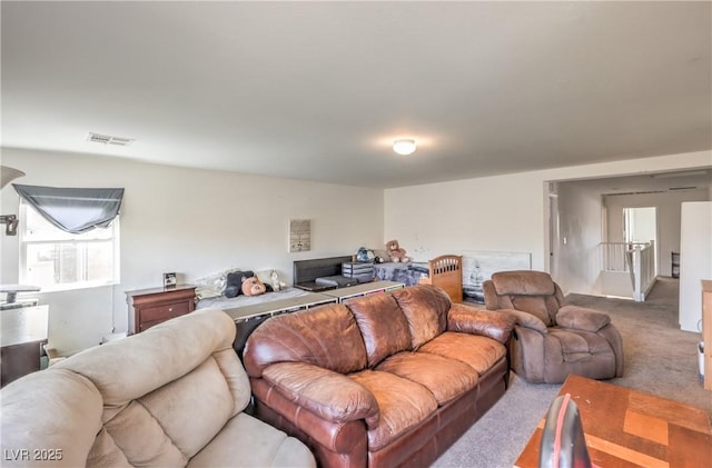 carpeted living room featuring visible vents