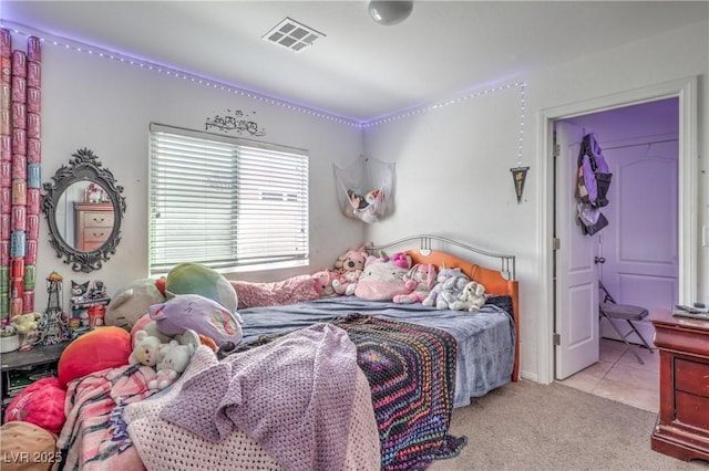 bedroom with visible vents and carpet floors