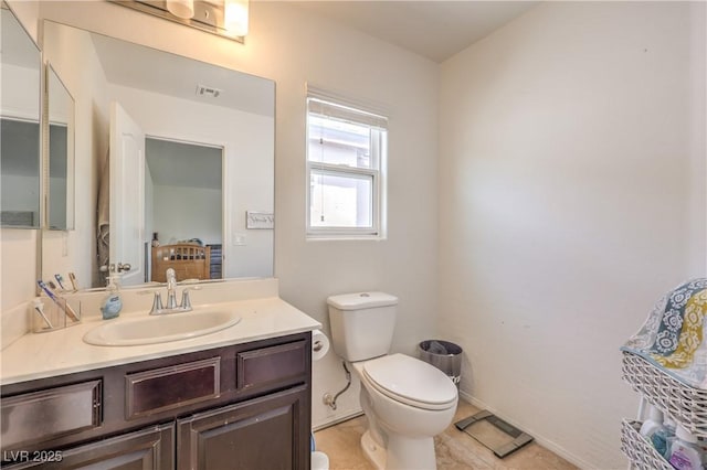 half bath with visible vents, toilet, and vanity
