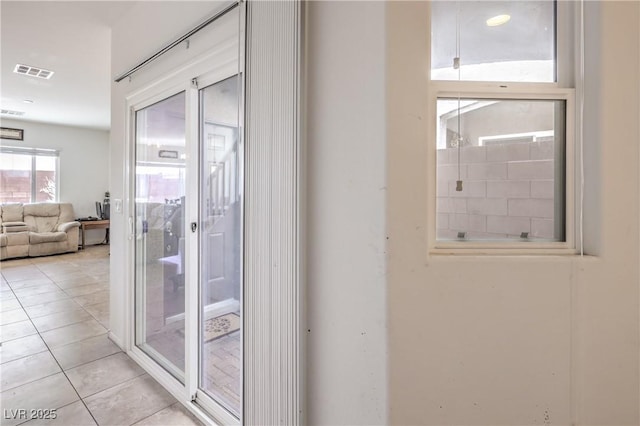 doorway with visible vents and light tile patterned flooring