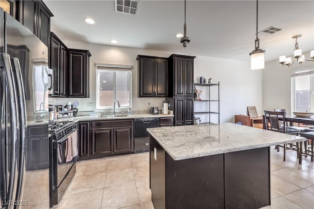kitchen featuring a sink, visible vents, a notable chandelier, and black appliances