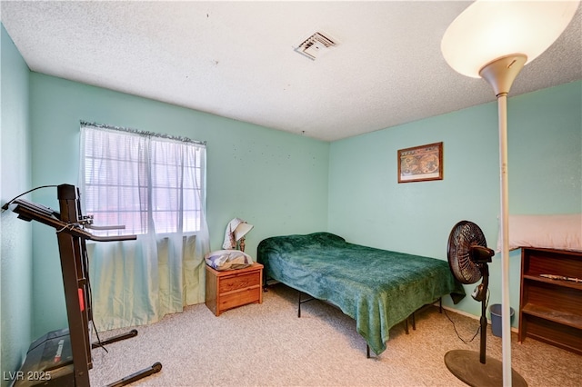 carpeted bedroom with visible vents and a textured ceiling