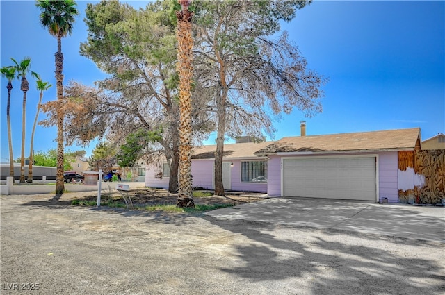 single story home with an attached garage and concrete driveway