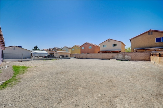view of yard featuring a fenced backyard and a residential view