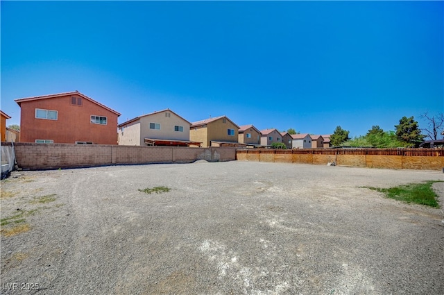view of yard with a residential view and a fenced backyard