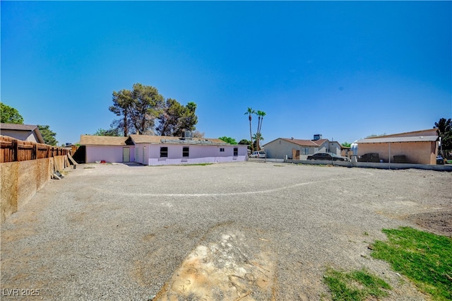 view of front facade with a residential view and fence