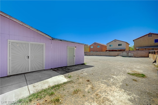 view of yard featuring an outbuilding and fence