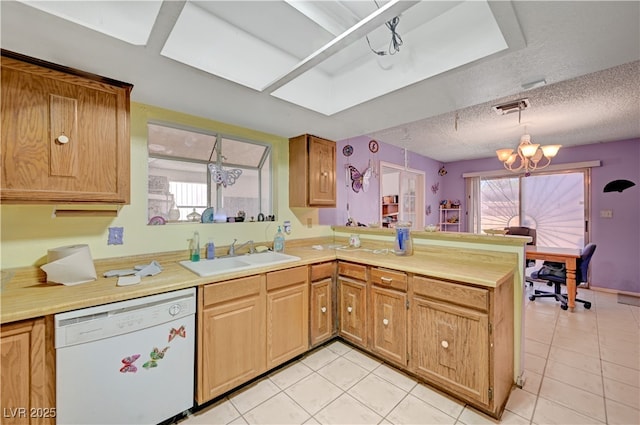 kitchen with a sink, light countertops, a peninsula, and dishwasher