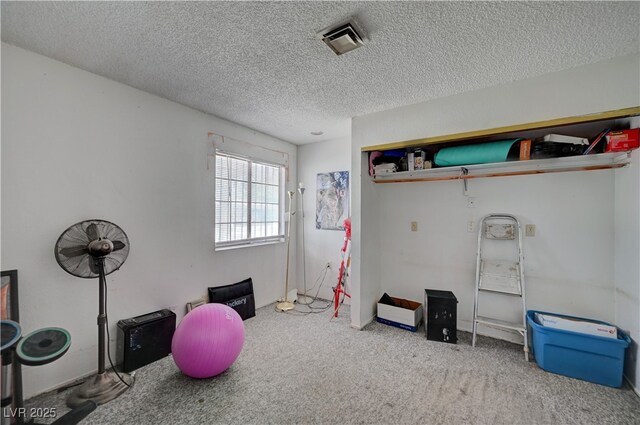 recreation room featuring visible vents, carpet, and a textured ceiling