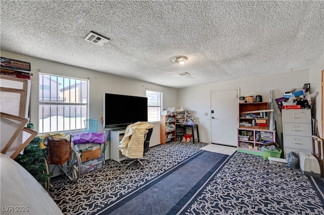 office with a textured ceiling, carpet, and visible vents
