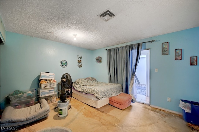 bedroom with concrete flooring, visible vents, and a textured ceiling